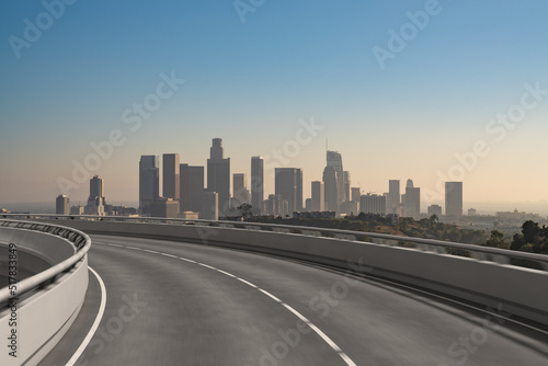 Empty urban asphalt road exterior with city buildings background. New modern highway concrete construction. Concept of way to success. Transportation logistic industry fast delivery. Los Angeles. USA. © VideoFlow