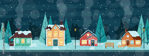 A snow-covered street with cozy houses. Winter evening in the village.