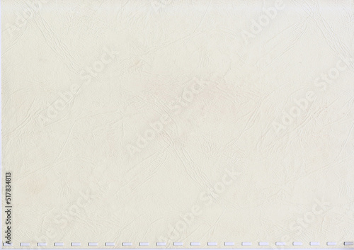 High resolution large image of an uncoated weathered textbook cover paper with square spiral holes wavy root like texture copy space for text for presentation background or high quality wallpaper