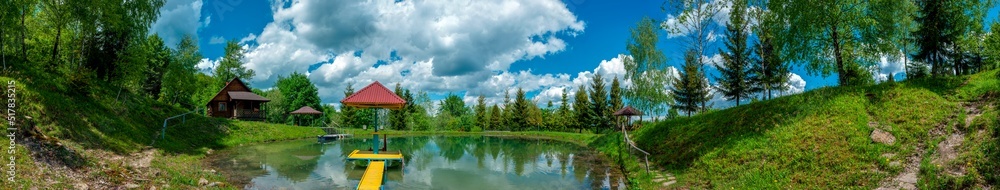 A panorama of a lake with a house, a place to rest by the water.