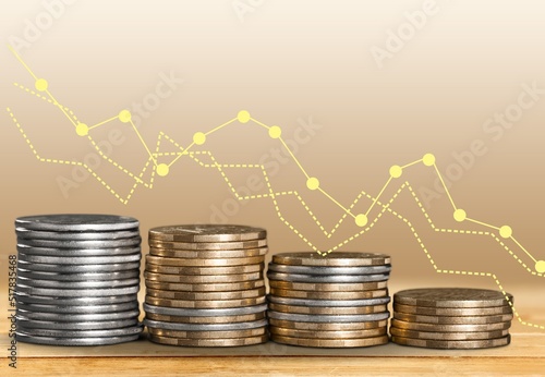 Inflation. The recession of the economy and the euro. The concept of economic stock exchange. Stacks of coins and a graph arrow pointing down.