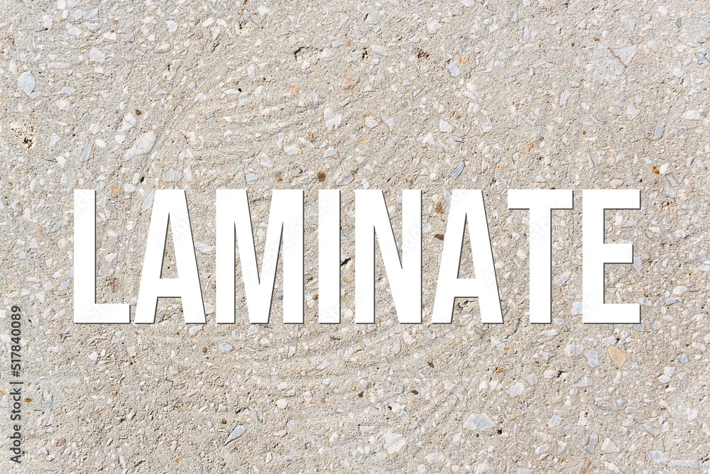 LAMINATE - word on concrete background. Cement floor, wall. LAMINATE - word on concrete background. Cement floor, wall.