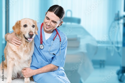 Fototapeta Naklejka Na Ścianę i Meble -  Veterinary Clinic Advertisement Concept. Happy male Nurse In Uniform Posing With Dog