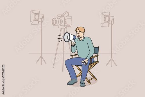 Film producer sitting on chair screaming in megaphone at shooting. Man movie director with loudspeaker manage scene. Vector illustration. 