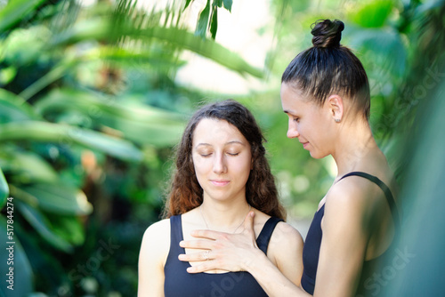 Yoga concept, meditation and sound therapy. Beautiful young girl at yoga session with her yoga and meditation teacher at tropical yoga retrear photo