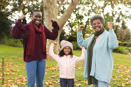 Image of happy african american grandmother, mother and daughter having fun in garden