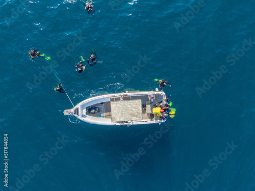 Group of scuba divers jumping from a boat © Martin Cox