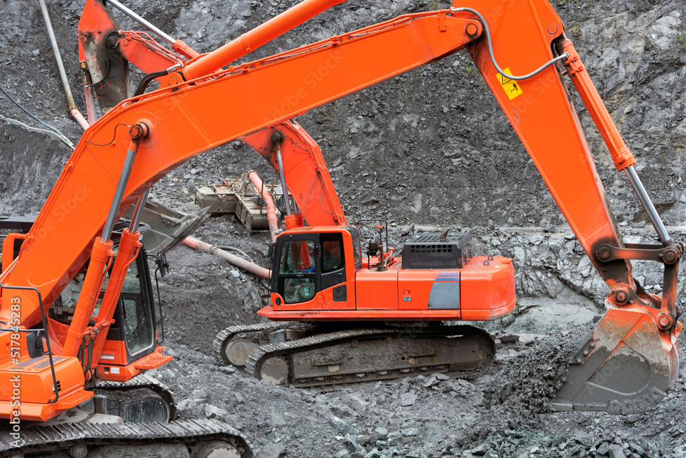 Open pit quarry, heavy equipment digs gravel construction industry