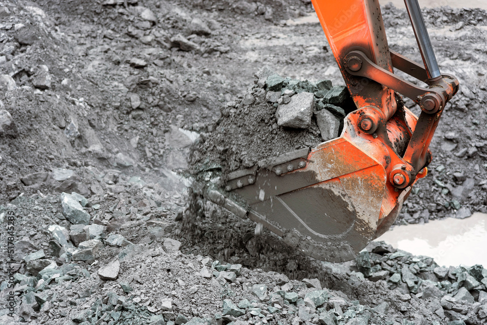 Open pit quarry, heavy equipment digs gravel: construction industry Open pit quarry, heavy equipment digs gravel: construction industry