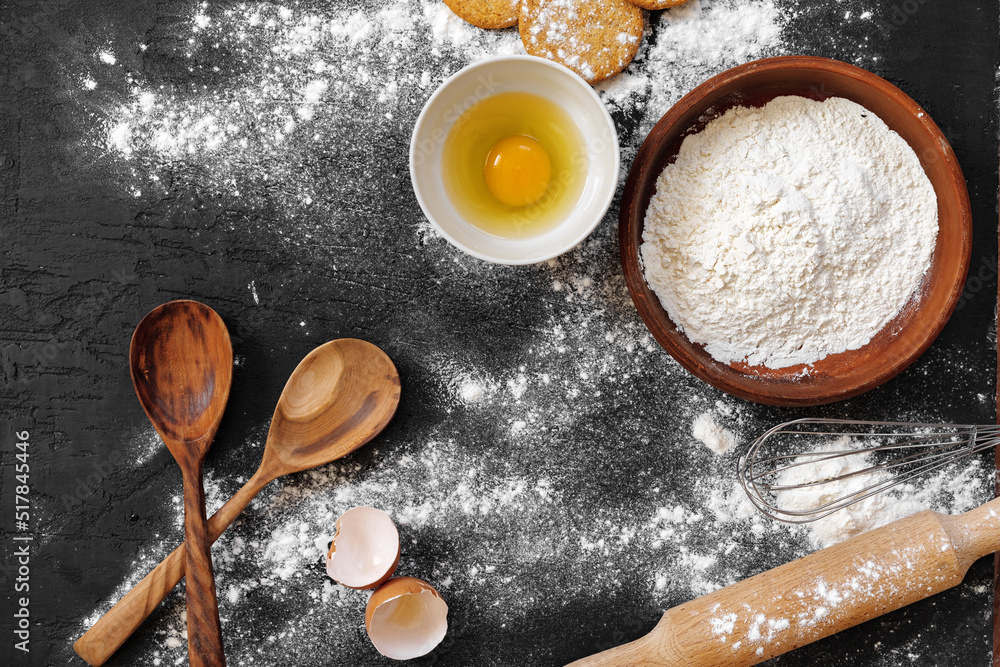Preparation for baking. Eggs and flour on black background Preparation for baking. Eggs and flour on black background