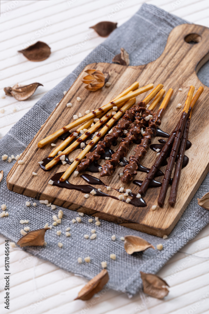 sweet chocolate stick on wooden plate with decorations.