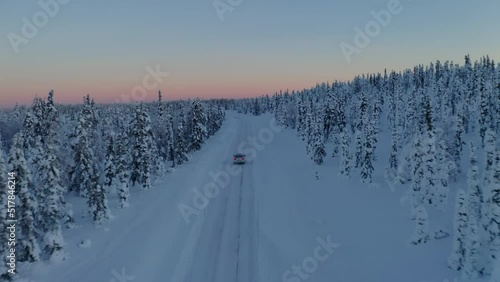 Wallpaper Mural Aerial view vehicle on journey through quiet snowy Sweden woodland landscape at sunset Torontodigital.ca
