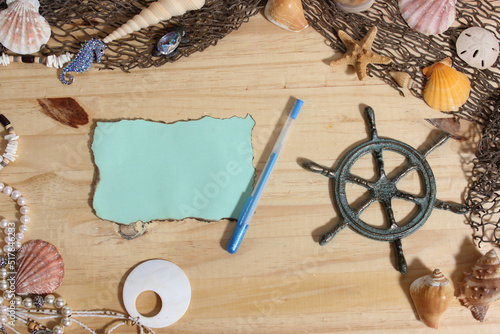Fototapeta Naklejka Na Ścianę i Meble -  Blank Paper With Burned Edges on Wooden Background With Sea Shells and Fishing Net. Nautical and Coastal Theme
