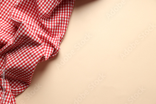 Red and white checkered tablecloth on beige background