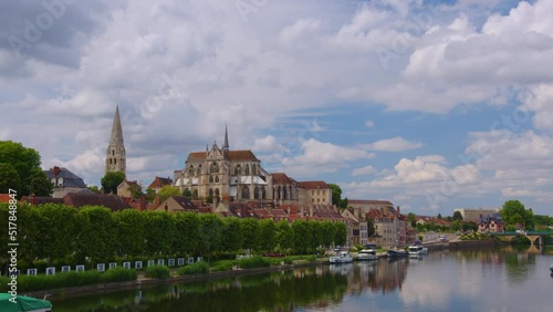 Time lapse. Beautiful clouds in the background of the old city. View of city landscape of Auxerre with Cathedral of Saint-Etienne on River Yonne, Burgundy, France photo