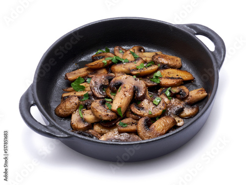 black ceramic bowl with fried mushrooms isolated on white background