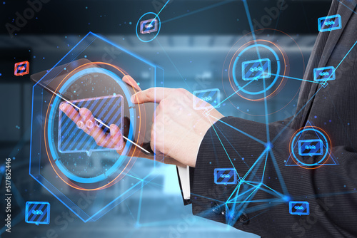 Close up of businessman hands using tablet with creative glowing connected communication hologram on blurry office interior background. Technology and wireless networking concept. Double exposure. photo