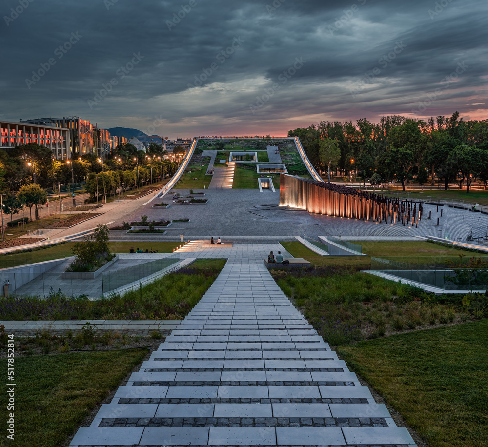 Budapest, Hungary - Illuminated rooftop garden of the Museum of at Ethnography City Park with dark clouds and colorful sky at sunset