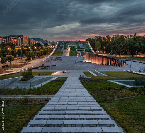 Obraz na płótnie Budapest, Hungary - Illuminated rooftop garden of the Museum of at Ethnography City Park with dark clouds and colorful sky at sunset w salonie