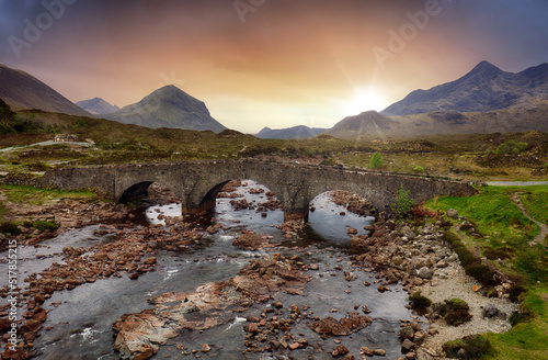 Sligachan old bridge on the Isle of Skye at beautiful sunset in Scotland. Nice landsape with river. photo