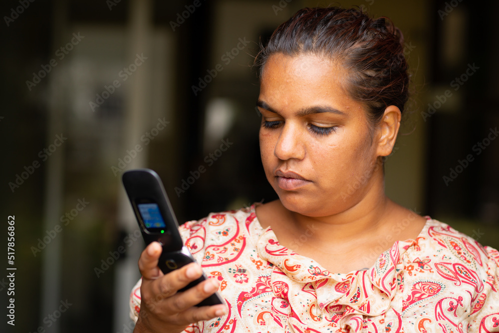 head and shoulders of lady looking at flip phone head and shoulders of lady looking at flip phone