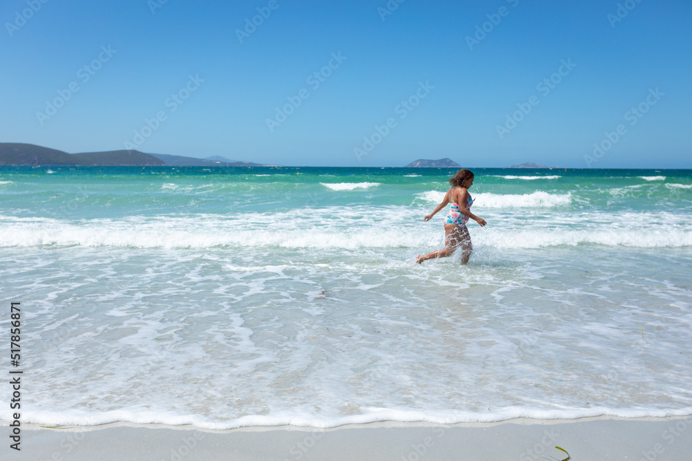 young lady running through the shallows on Middleton Beach young lady running through the shallows on Middleton Beach