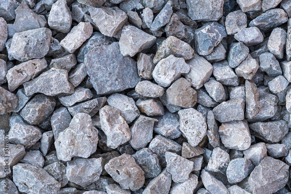 Textured surface of dirt road filled with large screenings of crushed stone. Textured surface of dirt road filled with large screenings of crushed stone.