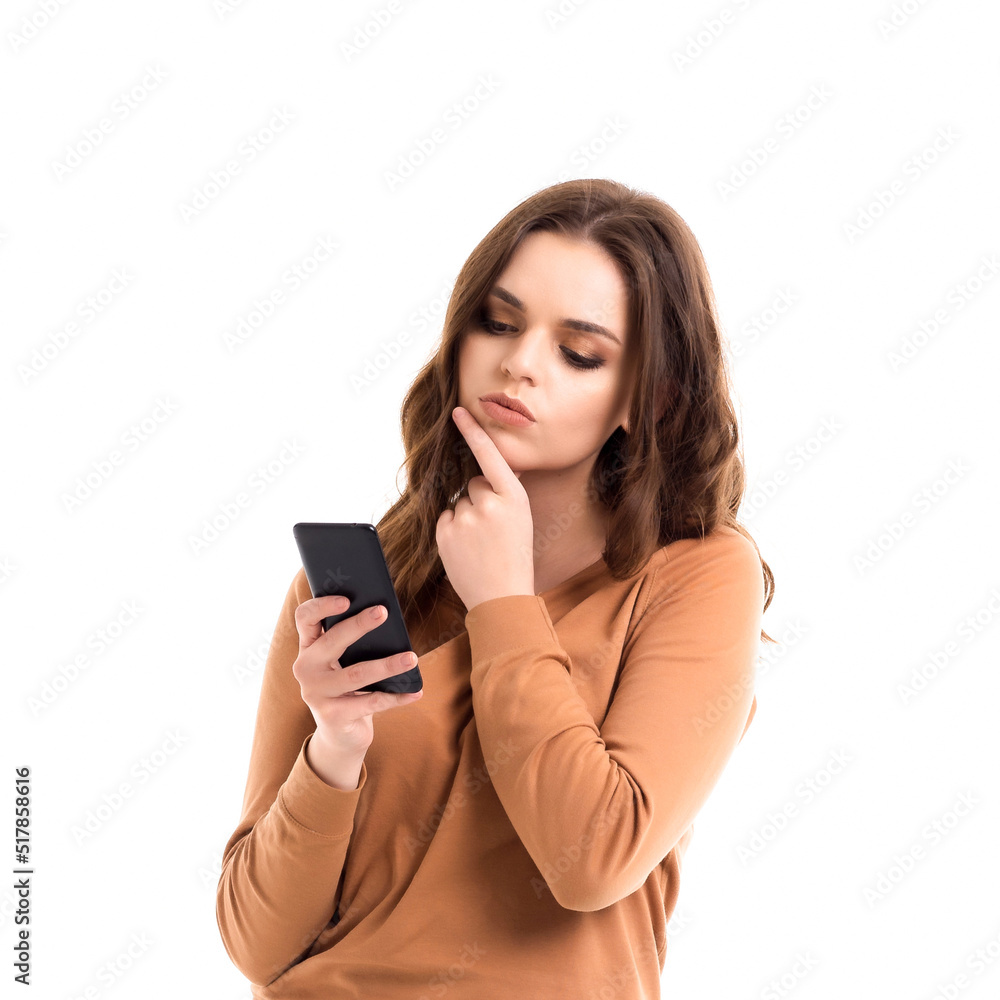 The girl reads messages on the phone. Online communication. The girl reads messages on the phone. Online communication.
