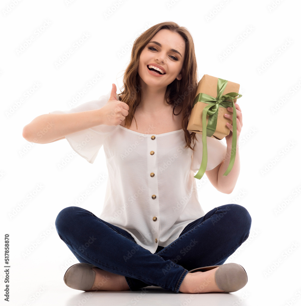 The girl is happy to receive a box with a gift. The girl is happy to receive a box with a gift.