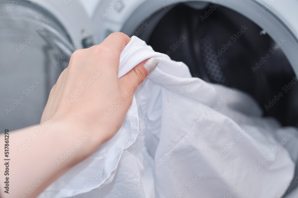 close up of white tidy linen in washing machine,household routine