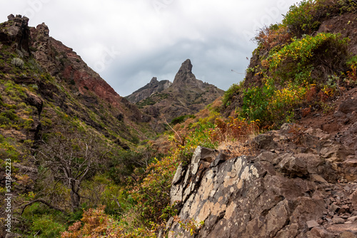 Panoramic view on El Dedo del Roque Pai crag, Roque Paez in the Anaga mountain range, Tenerife, Canary Islands, Spain, Europe. Scenic hiking trail from Afur to Taganana through canyon Barranco de Afur photo