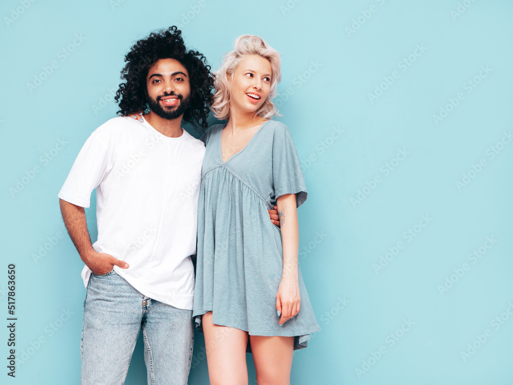 Smiling beautiful woman and her handsome boyfriend. Sexy cheerful multiracial family having tender moments on beige background in studio. Multiethnic models hugging. Embracing each other.Love concept Smiling beautiful woman and her handsome boyfriend. Sexy cheerful multiracial family having tender moments on beige background in studio. Multiethnic models hugging. Embracing each other.Love concept