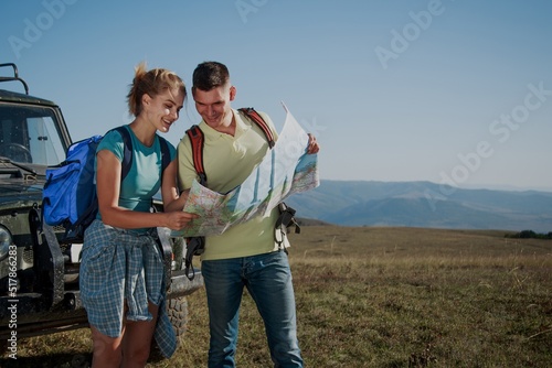 Two travelers people with map enjoying scenery nature view while hiking in mount