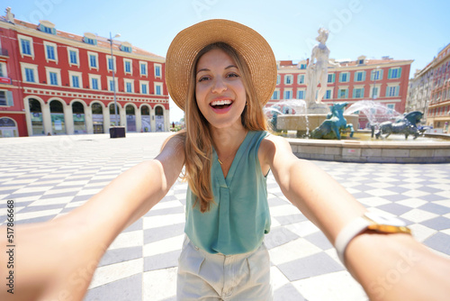Self portrait of smiling cheerful traveler woman in Massena square, Nice, Cote d'Azur, France photo