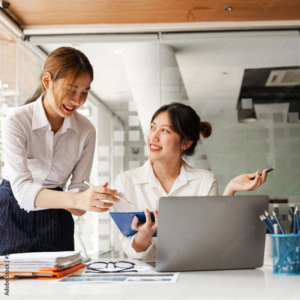 Business Asian discussing in modern office, small group asian female sale team staff smart solving plan data graph chart result job report talk on desk table at office. Business Asian discussing in modern office, small group asian female sale team staff smart solving plan data graph chart result job report talk on desk table at office.