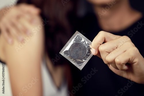 man holding a condom Prevent safe sex. Contraception. Contraceptive concept.