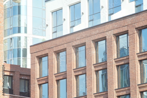 Horizontal full-color photo. Textural composition with parts of facades of city buildings. Urban landscape.