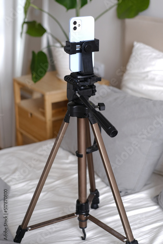 Close-up of a phone on a tripod filming a girl blogging