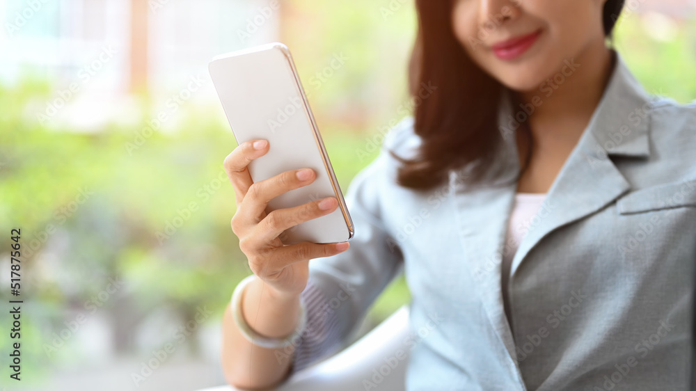 Smiling asian woman using mobile phone, communicating in social network