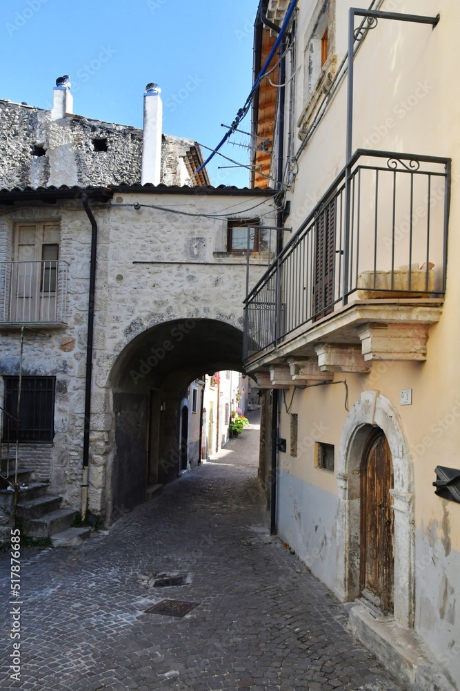A narrow street between the old stone houses of Cansano, a medieval village in the Abruzzo region of Italy.	