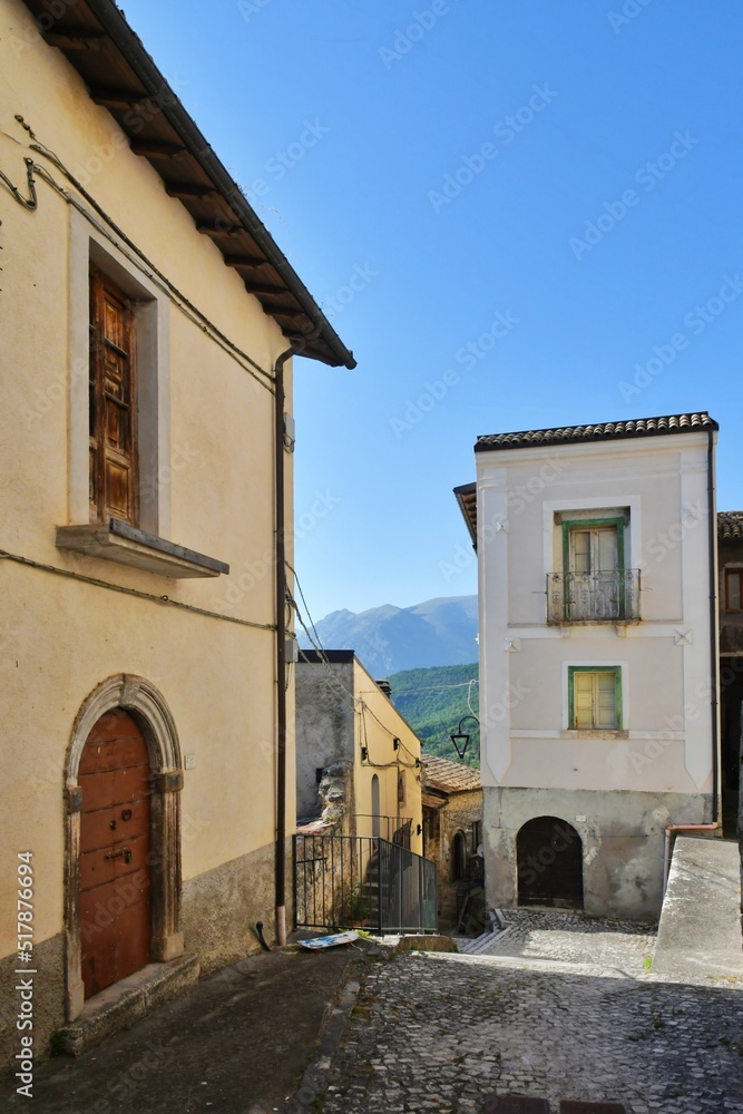 A narrow street between the old stone houses of Cansano, a medieval village in the Abruzzo region of Italy. A narrow street between the old stone houses of Cansano, a medieval village in the Abruzzo region of Italy.