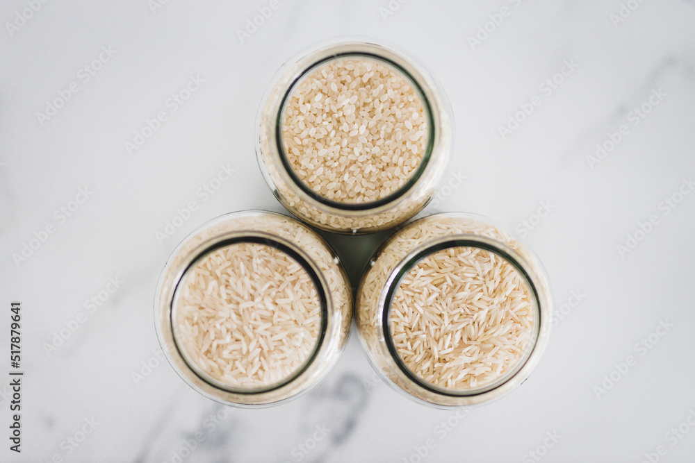 glass jar with white rice of including jasmine basmati and sushi rice, healthy pantry ingredients glass jar with white rice of including jasmine basmati and sushi rice, healthy pantry ingredients