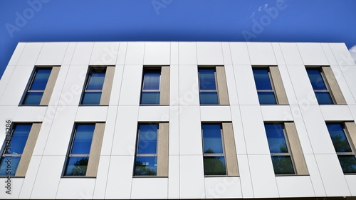 Office building with white aluminum composite panels. Facade wall made of glass and metal. Abstract modern business architecture.