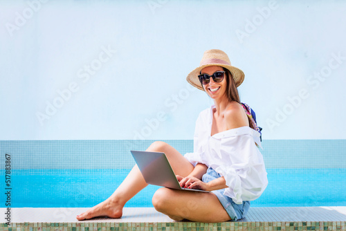 Woman relaxing by the pool at summer time