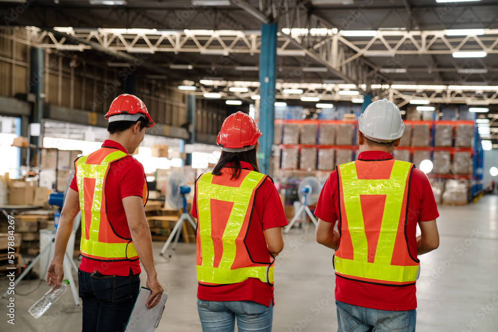 Warehouse worker walking and talking while checking product in warehouse, Logistic industry concept. Warehouse worker walking and talking while checking product in warehouse, Logistic industry concept.