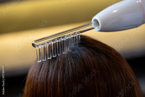 Close up of electostatic comb for hair treatment. Hair care concept photo
