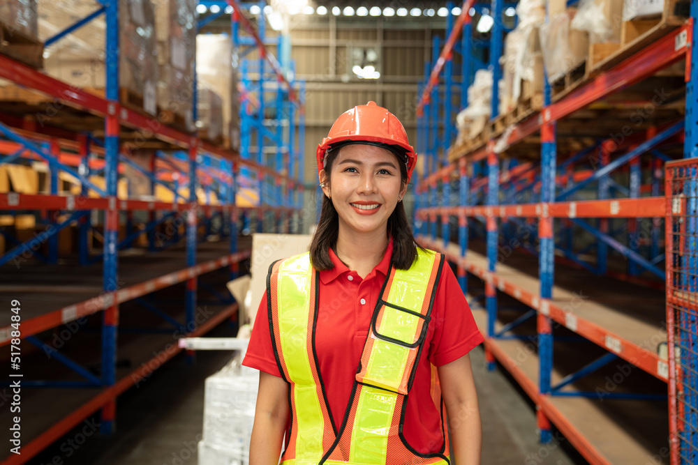 Portrait of female supervisor standing in warehouse with looking at camera.