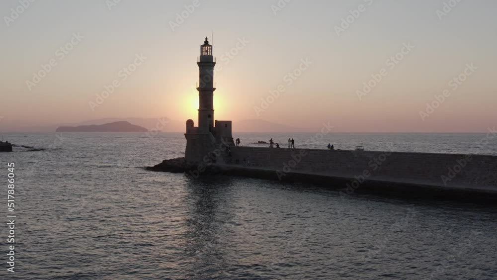 Aerial shot of Chania lighthouse in Crete, Greece with a sunset background Aerial shot of Chania lighthouse in Crete, Greece with a sunset background
