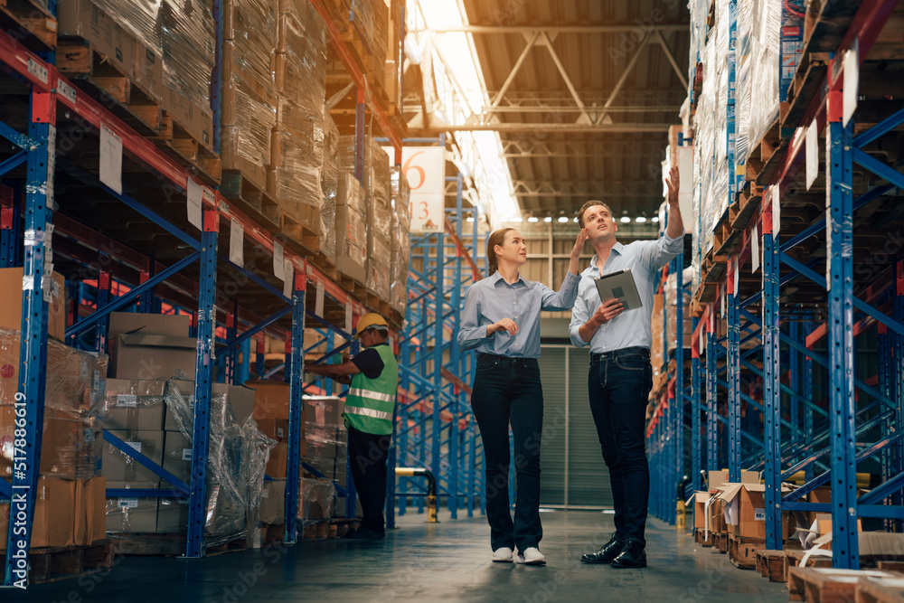 Warehouse manager talking and using digital tablet while checking product in warehouse, Logistic industry concept. Warehouse manager talking and using digital tablet while checking product in warehouse, Logistic industry concept.