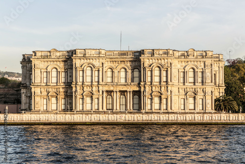 Beylerbeyi Palace on the coastline of Bosporus strait in golden hour. View from touristic boat on Bosporus. Istanbul, Turkey